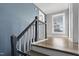 A staircase leads up to a landing with hardwood floors and a window at 107 N 12Th St, Erwin, NC 28339