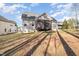 The back of the house shows the porch and back yard, showcasing a spacious area perfect for outdoor activities at 113 Palladium Ct, Elon, NC 27244