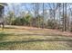 Expansive backyard featuring towering trees and beautiful grassy areas, perfect for outdoor recreation and enjoyment at 113 Palladium Ct, Elon, NC 27244