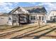 Exterior view of the home's rear facade, showcasing a porch and the expansive backyard, ideal for entertainment at 113 Palladium Ct, Elon, NC 27244