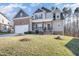 Attractive two-story home with a covered front porch and a combination of siding and stone accents at 113 Palladium Ct, Elon, NC 27244