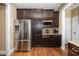 Kitchen featuring stainless steel refrigerator, dark cabinetry and granite countertops at 113 Palladium Ct, Elon, NC 27244