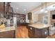 Kitchen with granite countertops, dark cabinetry, stainless steel appliances, and hardwood flooring at 113 Palladium Ct, Elon, NC 27244