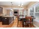 Eat in kitchen and living room with stone fireplace and hardwood flooring at 113 Palladium Ct, Elon, NC 27244