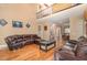 Spacious living room with high ceilings, hardwood floors, and comfortable leather seating at 113 Palladium Ct, Elon, NC 27244