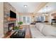 Living room featuring a stone fireplace, hardwood floors and a white sofa at 113 Palladium Ct, Elon, NC 27244