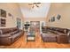Large living room featuring vaulted ceilings, hardwood floors, and ample seating at 113 Palladium Ct, Elon, NC 27244