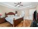 Comfortable main bedroom showcasing hardwood floors, a ceiling fan, and ample space at 113 Palladium Ct, Elon, NC 27244