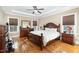 Inviting main bedroom with hardwood floors, ceiling fan, and tray ceiling at 113 Palladium Ct, Elon, NC 27244