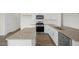 Modern kitchen with granite countertops, stainless steel appliances, and white cabinetry at 113 Paper Birch Way, Fuquay Varina, NC 27526