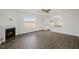 Open living room with a fireplace and access to a modern kitchen with an island at 113 Paper Birch Way, Fuquay Varina, NC 27526