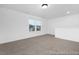 Upstairs bonus room with neutral carpet and natural light from two large windows at 113 Seneca Dr # 759, Louisburg, NC 27549