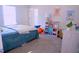 Bright bedroom features cute posters, colorful storage cubes, and cozy carpeting at 1136 Knotty Oaks Dr, Apex, NC 27523