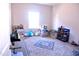 Bedroom with area rug providing a soft focal point and enhancing the room's cozy atmosphere at 1136 Knotty Oaks Dr, Apex, NC 27523