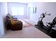 Relaxing bonus room features reclining furniture, large window, and dedicated exercise space at 1136 Knotty Oaks Dr, Apex, NC 27523
