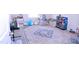 Spacious bonus room with area rug, perfect for a playroom or additional living space at 1136 Knotty Oaks Dr, Apex, NC 27523