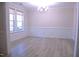 Dining room boasts wainscoting, wood-look floors, natural light from large window at 1136 Knotty Oaks Dr, Apex, NC 27523