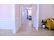 Hallway with wood-look floors connects to a living room, featuring wainscoting at 1136 Knotty Oaks Dr, Apex, NC 27523