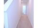 Hallway featuring carpeted floors and neutral walls, leading to a bathroom and additional rooms at 1136 Knotty Oaks Dr, Apex, NC 27523