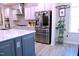 Modern kitchen with stainless steel refrigerator and white cabinets offer an inviting ambiance at 1136 Knotty Oaks Dr, Apex, NC 27523