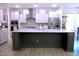 Stylish kitchen island with white countertop, grey cabinets, and modern pendant lighting at 1136 Knotty Oaks Dr, Apex, NC 27523