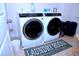 Well-equipped laundry room with modern, front-loading washer and dryer for convenient and efficient laundry care at 1136 Knotty Oaks Dr, Apex, NC 27523
