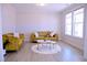 Bright living room with comfortable seating, wood-look floors, large window, and decorative rug at 1136 Knotty Oaks Dr, Apex, NC 27523