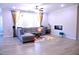 Spacious living room with ample seating, natural light, fireplace, and ceiling fan at 1136 Knotty Oaks Dr, Apex, NC 27523