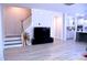 Open-concept living room with hardwood floors and staircase, bright and inviting at 1136 Knotty Oaks Dr, Apex, NC 27523