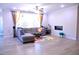 Spacious living room with ample seating, natural light, fireplace, and ceiling fan at 1136 Knotty Oaks Dr, Apex, NC 27523