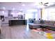 Bright and spacious living room with open-concept kitchen and dining area, ideal for entertaining at 1136 Knotty Oaks Dr, Apex, NC 27523