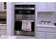 Close up of a stainless steel oven and microwave combo with white cabinets at 1136 Knotty Oaks Dr, Apex, NC 27523