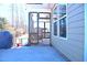 Covered patio with wicker hanging chair and view of the well-maintained lawn at 1136 Knotty Oaks Dr, Apex, NC 27523