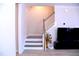 Staircase with wooden steps and white risers leads to the upper level at 1136 Knotty Oaks Dr, Apex, NC 27523