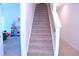 Carpeted stairway with painted wood handrail to upper level at 1136 Knotty Oaks Dr, Apex, NC 27523