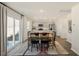 Bright dining area with sliding glass doors and decorative rug adjoining modern kitchen at 120 Paper Birch Way, Fuquay Varina, NC 27526