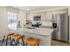 Kitchen boasts stainless steel appliances, a spacious island with seating, and ample cabinet space at 120 Paper Birch Way, Fuquay Varina, NC 27526