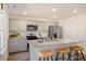 Modern kitchen with stainless appliances, granite countertops, breakfast bar, and adjoining dining area at 120 Paper Birch Way, Fuquay Varina, NC 27526