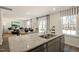Open concept living features granite countertops, breakfast bar and view to living room at 120 Paper Birch Way, Fuquay Varina, NC 27526