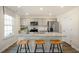 Bright kitchen with an island, granite countertops, stainless appliances and breakfast bar at 120 Paper Birch Way, Fuquay Varina, NC 27526
