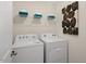 Practical laundry room featuring a washer, dryer, and shelving for storage at 120 Paper Birch Way, Fuquay Varina, NC 27526