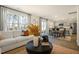 Bright living room with sofa, kitchen view, large windows, and modern decor at 120 Paper Birch Way, Fuquay Varina, NC 27526