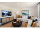Cozy living room featuring a sectional sofa, modern decor, and a large TV at 120 Paper Birch Way, Fuquay Varina, NC 27526