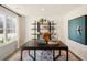 Bright home office with large window, black desk, stylish shelving, and contemporary decor at 120 Paper Birch Way, Fuquay Varina, NC 27526