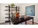 Bright home office with large window, black desk, stylish shelving, and contemporary decor at 120 Paper Birch Way, Fuquay Varina, NC 27526