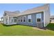Back of house featuring covered patio and sliding glass doors leading to green grass of backyard at 121 Willow Cameron Way, Angier, NC 27501