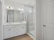 Modern bathroom with a double vanity, glass shower, and wood-look flooring at 121 Willow Cameron Way, Angier, NC 27501