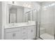 Modern bathroom with a double vanity, glass shower, and wood-look flooring at 121 Willow Cameron Way, Angier, NC 27501
