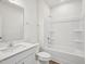 This is a well-lit bathroom with a shower and tub combo, a toilet, and a vanity with ample counter space at 121 Willow Cameron Way, Angier, NC 27501