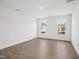 Bright bedroom with wood-look flooring, neutral paint, and view of the neighborhood at 121 Willow Cameron Way, Angier, NC 27501